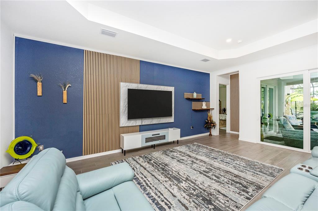 12845 Tulum Loop Venice, FL 34293 - Photo 21 of 100 a living room with furniture and a flat screen tv