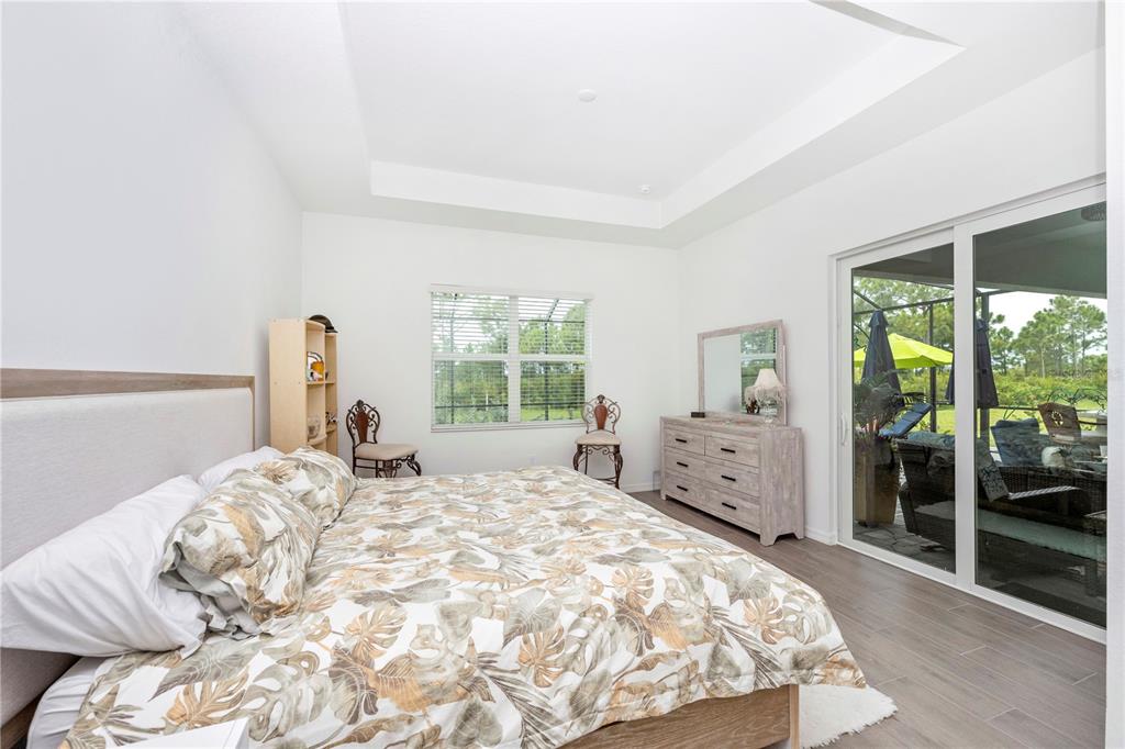 12845 Tulum Loop Venice, FL 34293 - Photo 24 of 100 a large bed sitting in a bedroom next to a window