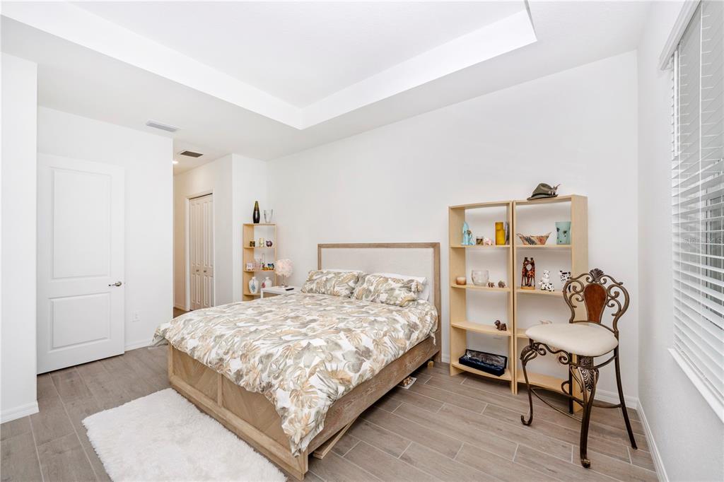 12845 Tulum Loop Venice, FL 34293 - Photo 25 of 100 a bedroom with a bed and a chair in it