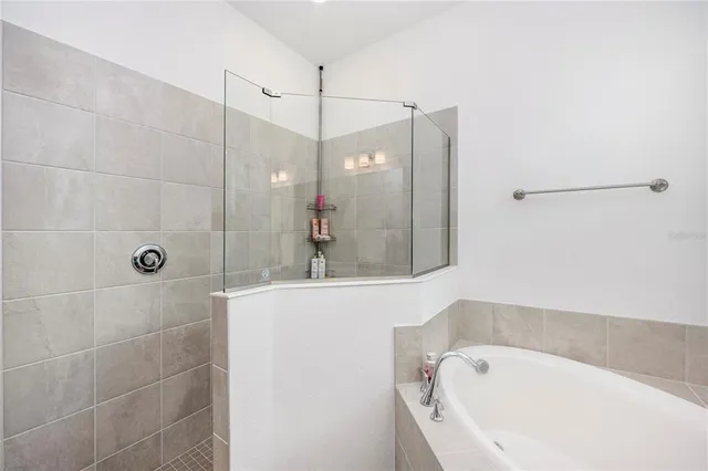 a living room with furniture a flat screen tv and a large window