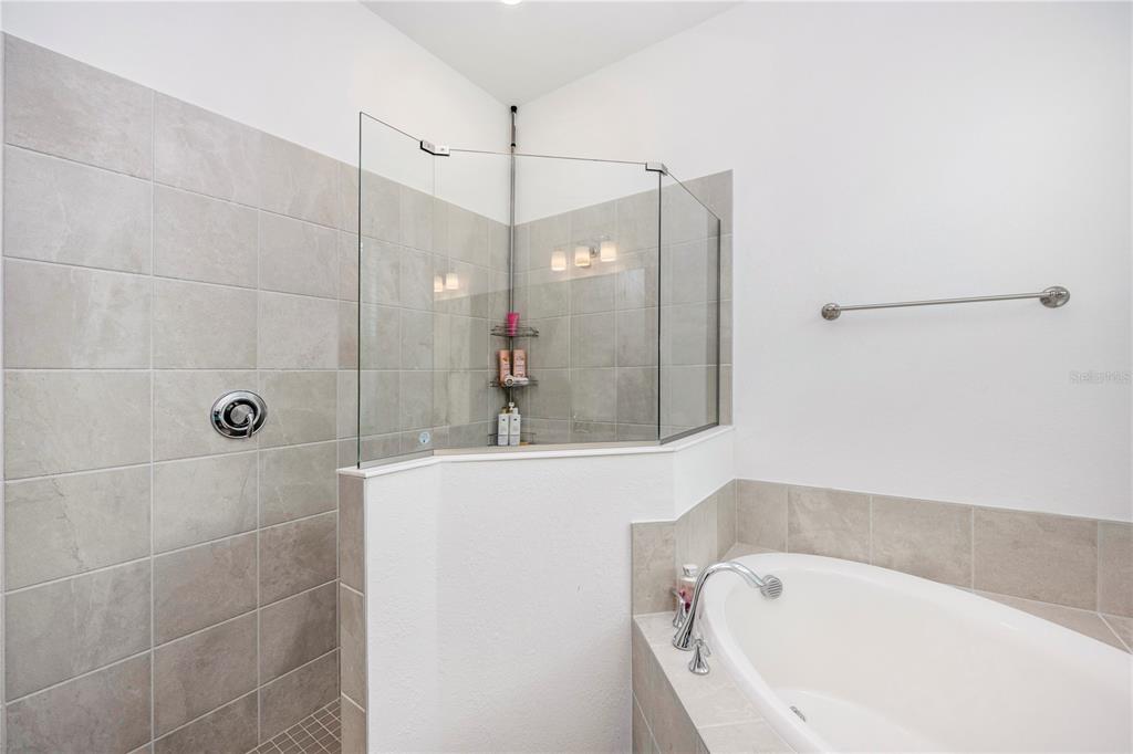 12845 Tulum Loop Venice, FL 34293 - Photo 28 of 100 a bathroom with a bathtub and a shower