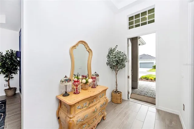 a large white kitchen with a large window and stainless steel appliances