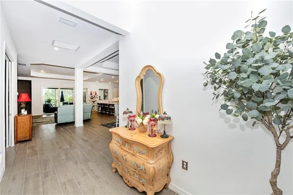 a kitchen with stainless steel appliances a sink a table and chair