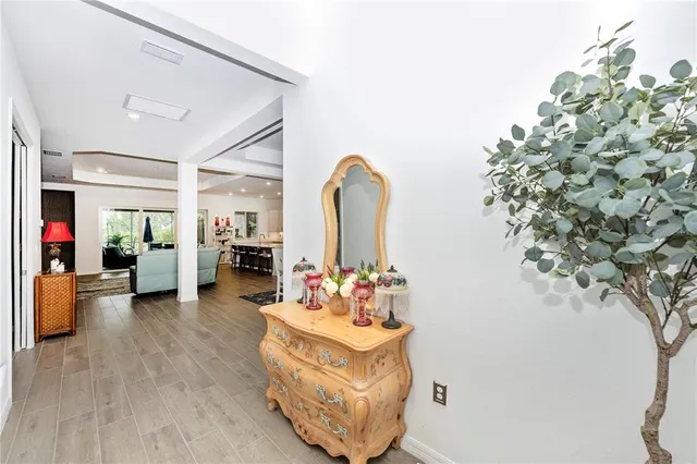 a kitchen with stainless steel appliances a sink a table and chair