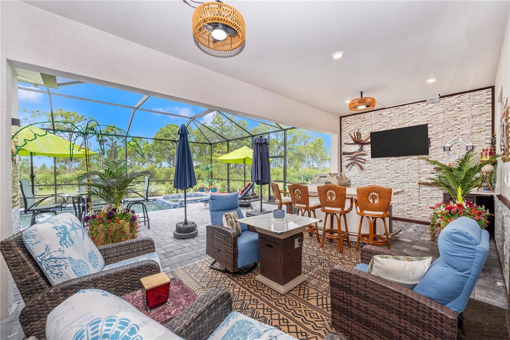 12845 Tulum Loop Venice, FL 34293 - Photo 41 of 100 a living room with furniture a flat screen tv and a large window