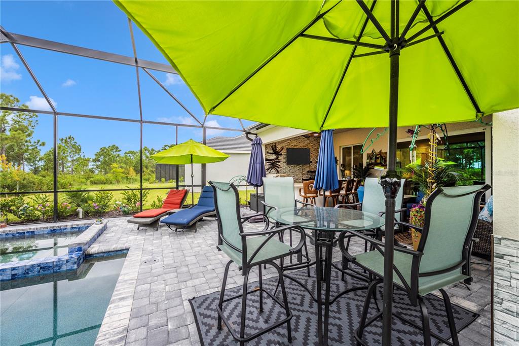 12845 Tulum Loop Venice, FL 34293 - Photo 48 of 100 a view of an outdoor sitting area with furniture and umbrella