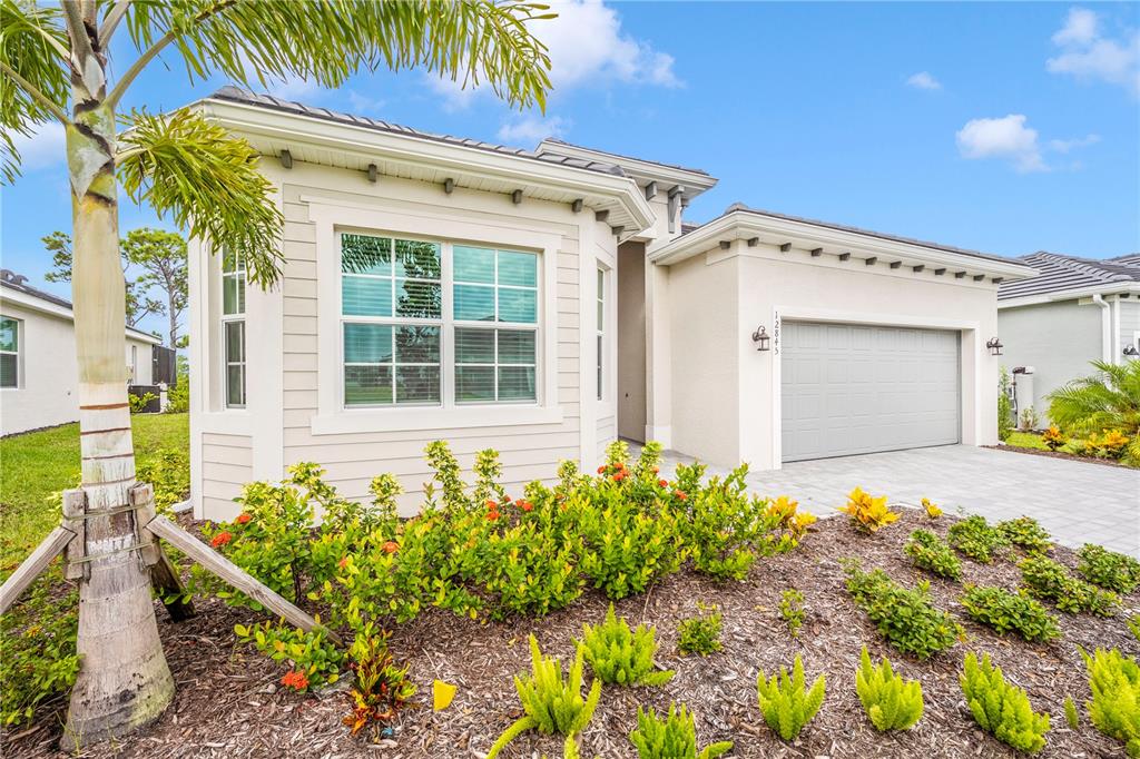 12845 Tulum Loop Venice, FL 34293 - Photo 57 of 100 a front view of a house with a yard