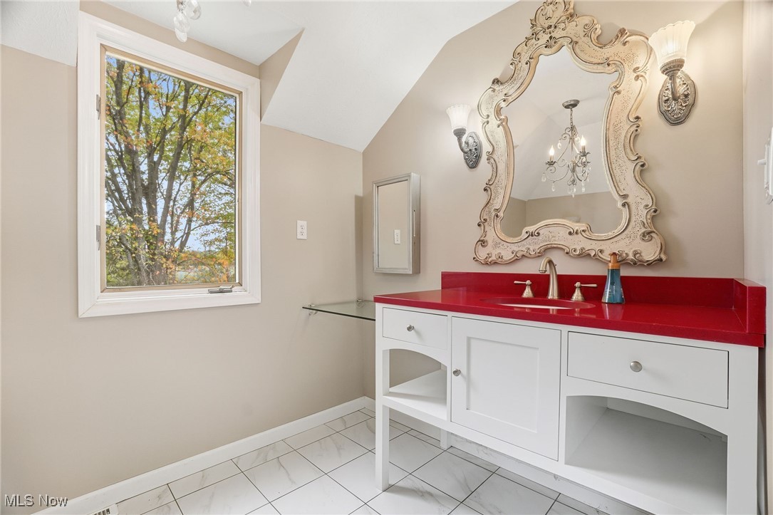 11710 Butternut Road Chardon, OH 44024 - Photo 27 of 48 Bathroom with vanity, lofted ceiling, and light tile patterned floors