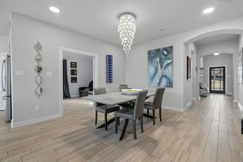 a view of a dining room with furniture and wooden floor