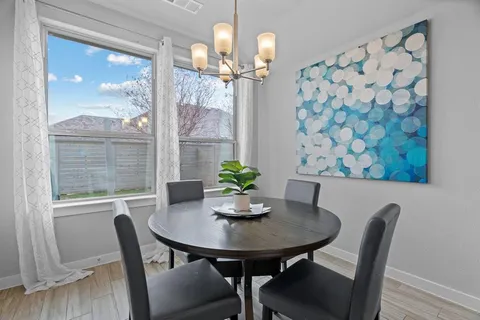 a dining room with furniture and window