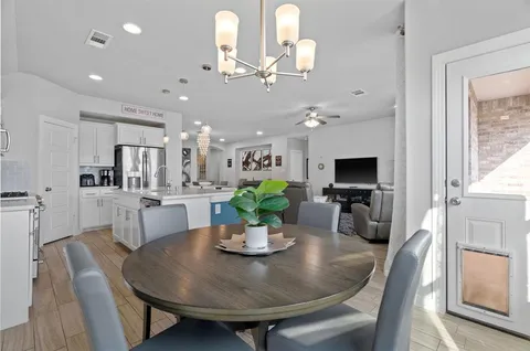 a view of a dining room with furniture and a chandelier