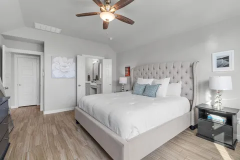 a bedroom with a bed and a chandelier