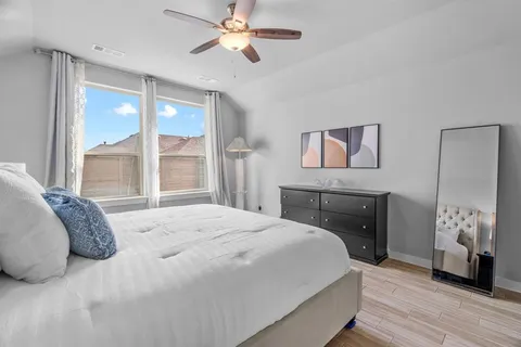 a bedroom with a bed and a large window