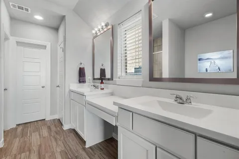 a bathroom with 2 sink and a mirror