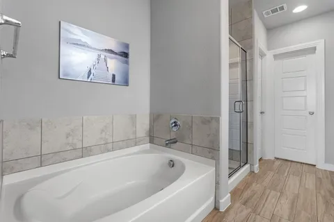 a white bath tub sitting next to a shower