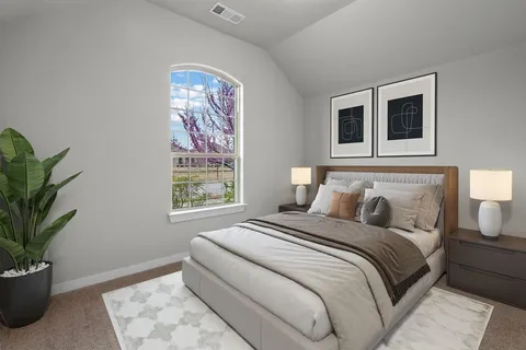a bedroom with bed and a potted plant