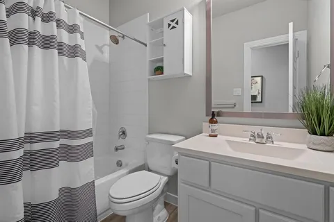 a bathroom with a sink toilet and shower