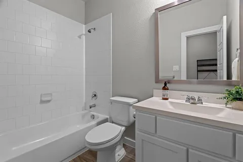 a bathroom with a sink toilet a mirror and shower