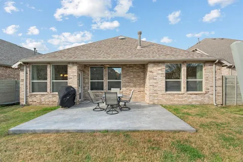 a front view of a house with sitting area and garden