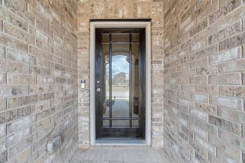 a view of front door with furniture and a window