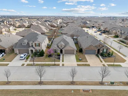 an aerial view of residential houses with outdoor space