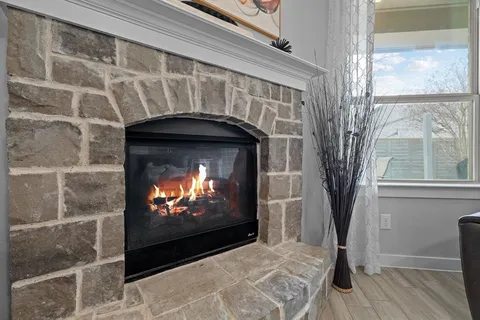 a living room with a fireplace and a flat screen tv