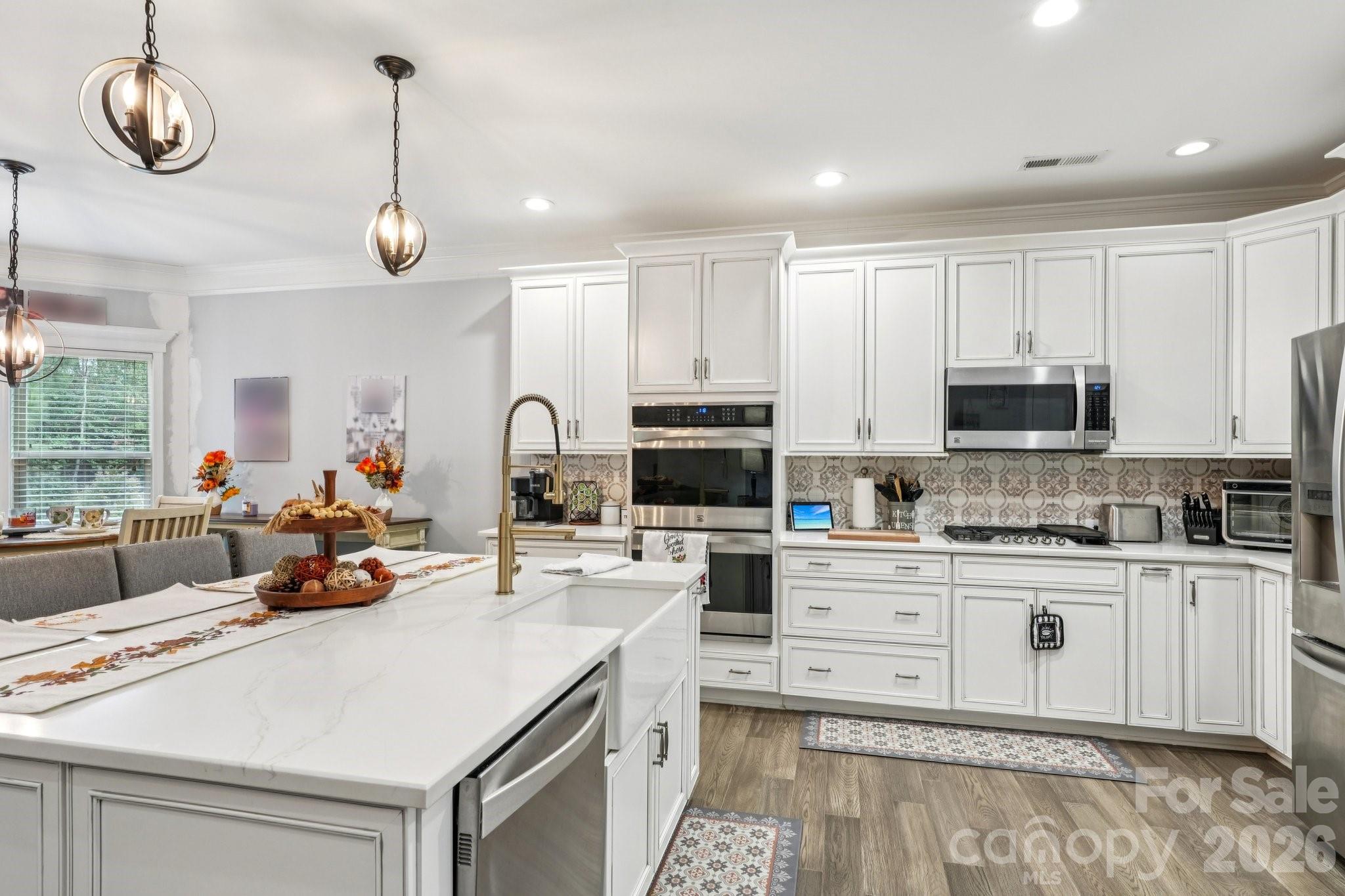 4013 Spindrift Cove Denver, NC 28037 - Photo 13 of 46 a kitchen with stainless steel appliances kitchen island granite countertop a sink and cabinets
