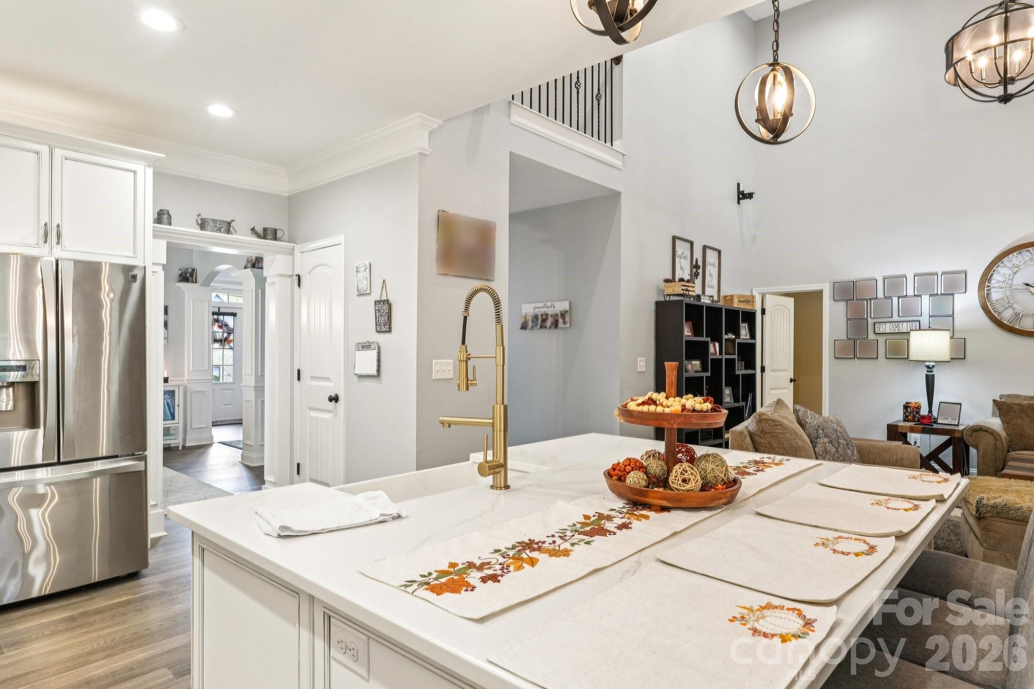 4013 Spindrift Cove Denver, NC 28037 - Photo 14 of 46 a kitchen with stainless steel appliances kitchen island granite countertop a table chairs and a refrigerator