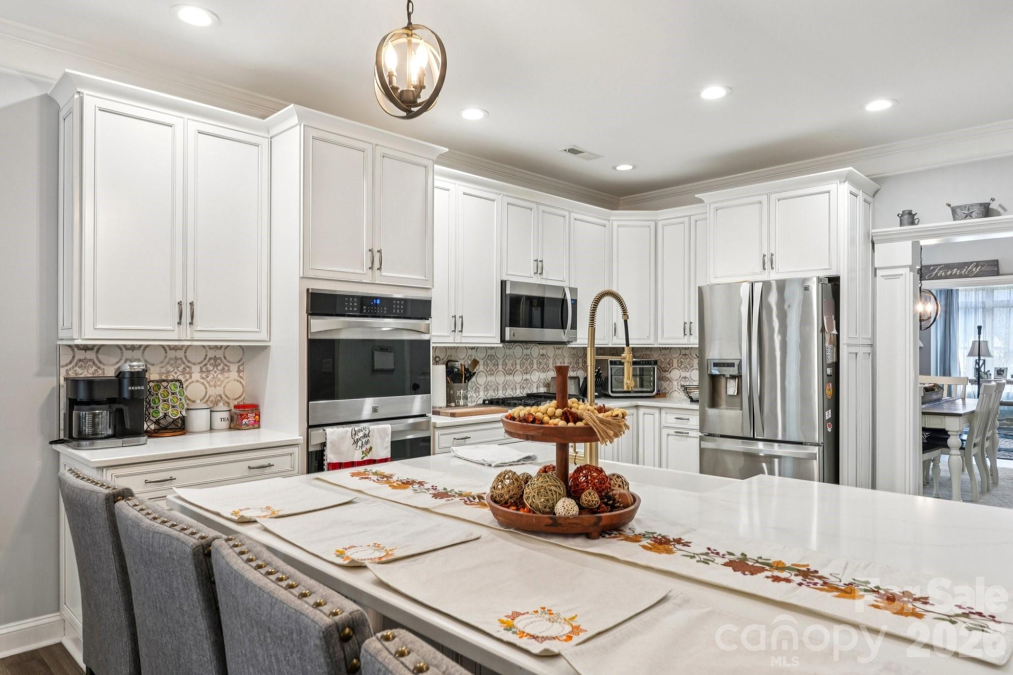 4013 Spindrift Cove Denver, NC 28037 - Photo 15 of 46 a kitchen with stainless steel appliances granite countertop a sink stove and refrigerator