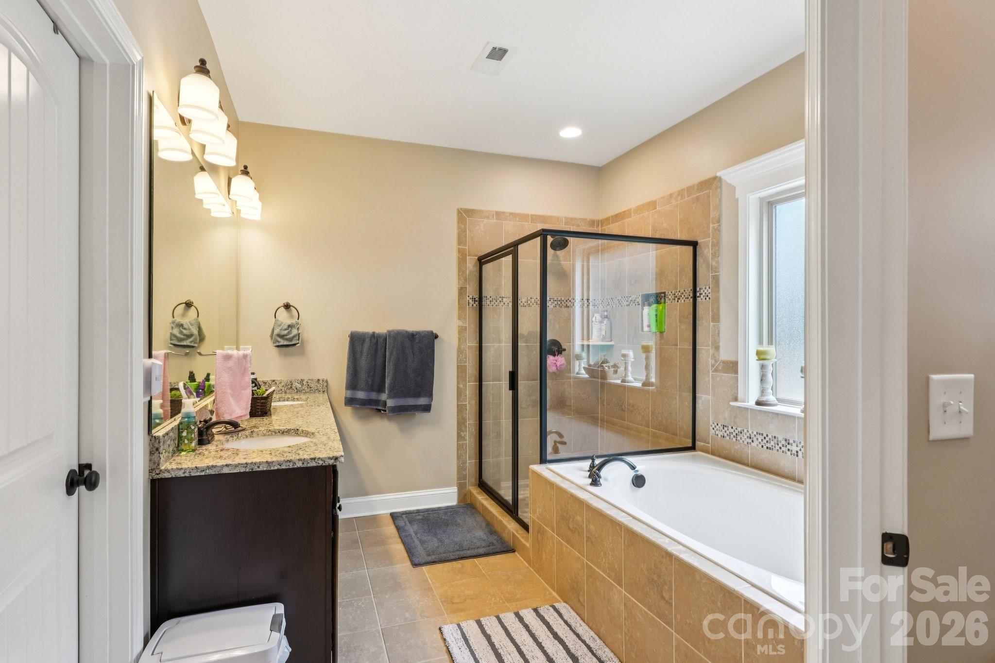 4013 Spindrift Cove Denver, NC 28037 - Photo 19 of 46 a bathroom with a tub mirror and sink
