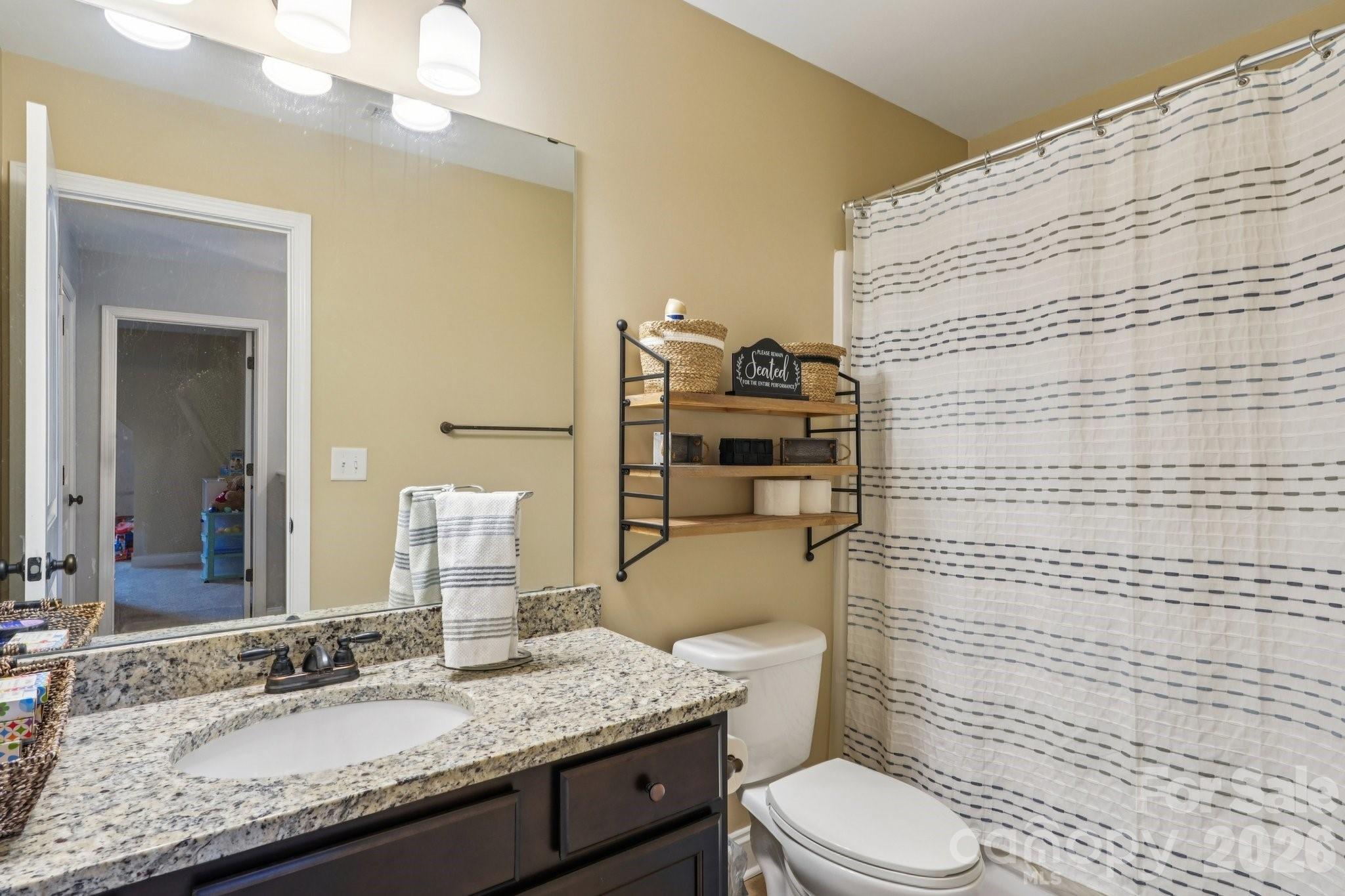 4013 Spindrift Cove Denver, NC 28037 - Photo 26 of 46 a bathroom with a granite countertop toilet sink and mirror