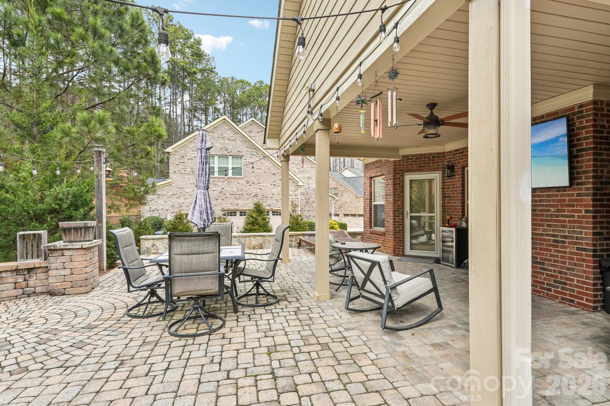 4013 Spindrift Cove Denver, NC 28037 - Photo 31 of 46 a view of patio with a table and chairs and floor to ceiling window