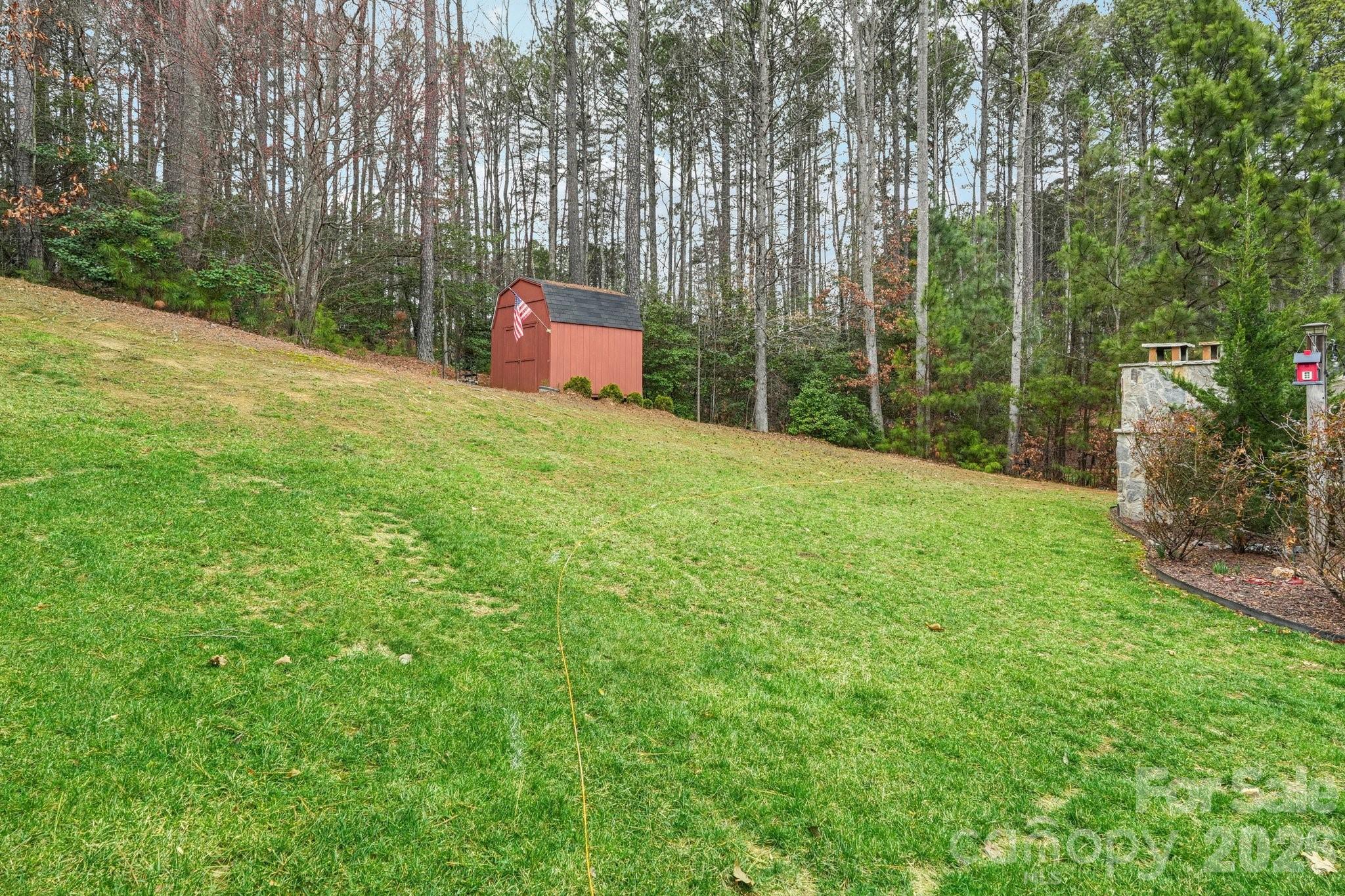 4013 Spindrift Cove Denver, NC 28037 - Photo 35 of 46 a backyard of a house with lots of green space and a fountain