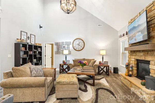 a living room with furniture a fireplace and a window