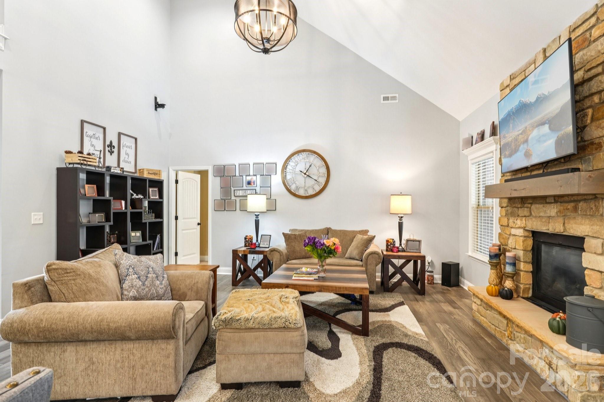 4013 Spindrift Cove Denver, NC 28037 - Photo 9 of 46 a living room with furniture a clock and a fireplace