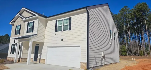 a view of a house with a backyard