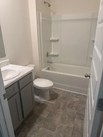 a bathroom with a sink a toilet and a bathtub
