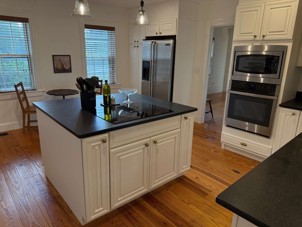 105 Elm Street, Unit A Andover, MA 01810 - Photo 14 of 40 a kitchen with stainless steel appliances granite countertop a sink a stove a refrigerator and island