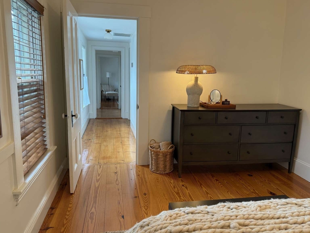 105 Elm Street, Unit A Andover, MA 01810 - Photo 23 of 40 a bedroom with a bed and wooden floor