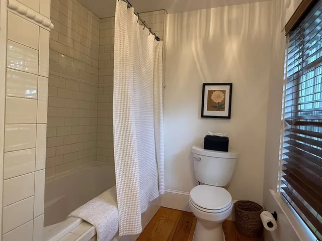 a bedroom with a bed a table and chair