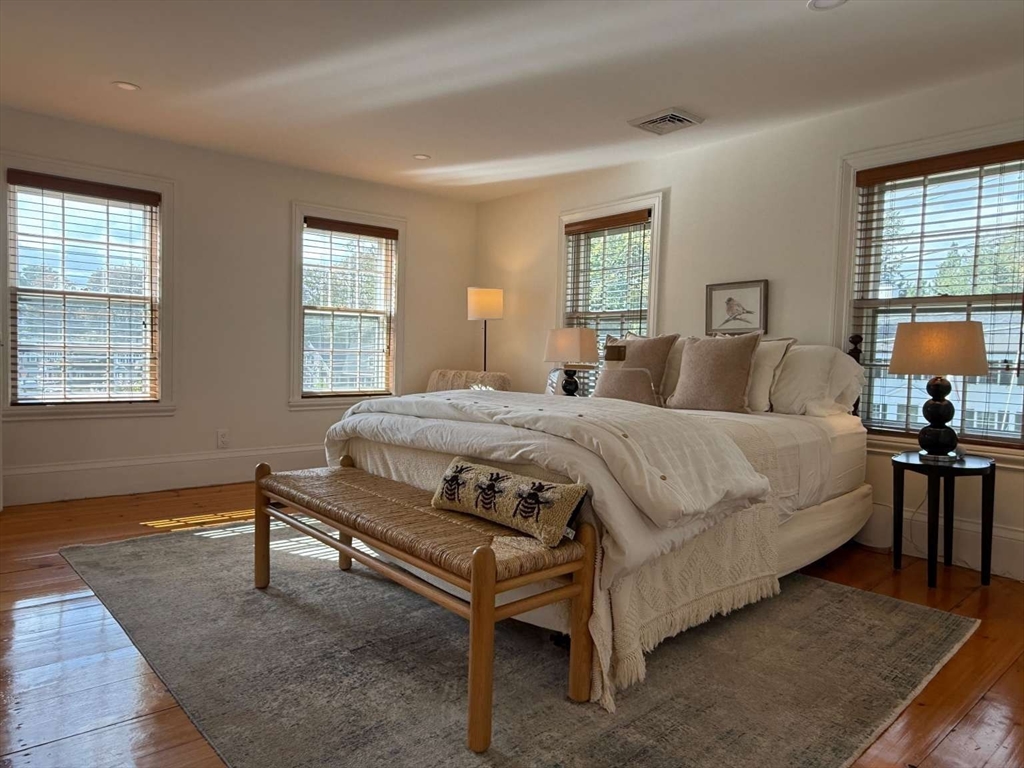 105 Elm Street, Unit A Andover, MA 01810 - Photo 27 of 40 a bedroom with a bed a table and chair