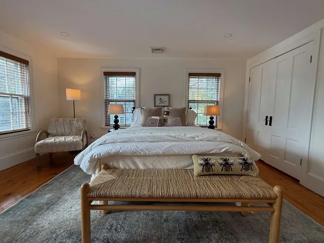 a view of a bedroom with a bed and a window