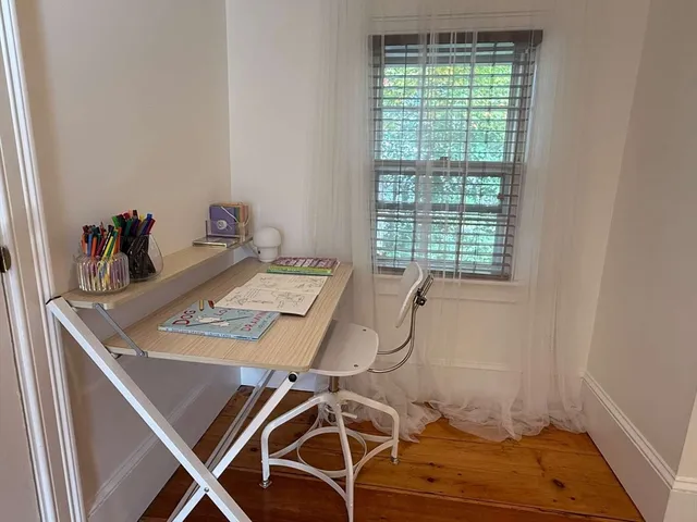 a view of a house with backyard sitting area and garden