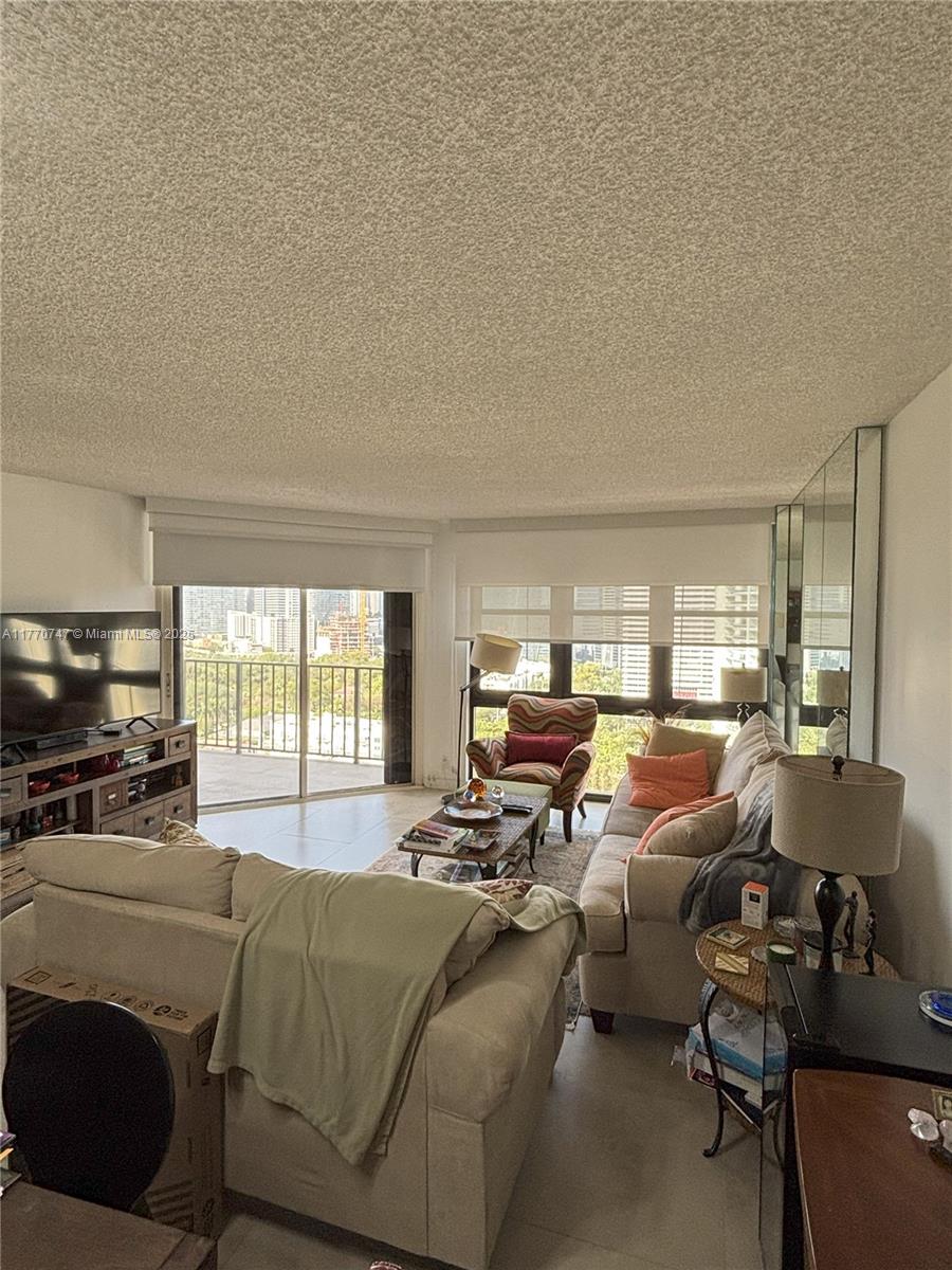 1901 Brickell Avenue, Unit B2310 Miami, FL 33129 - Photo 11 of 16 a living room with furniture and a large window