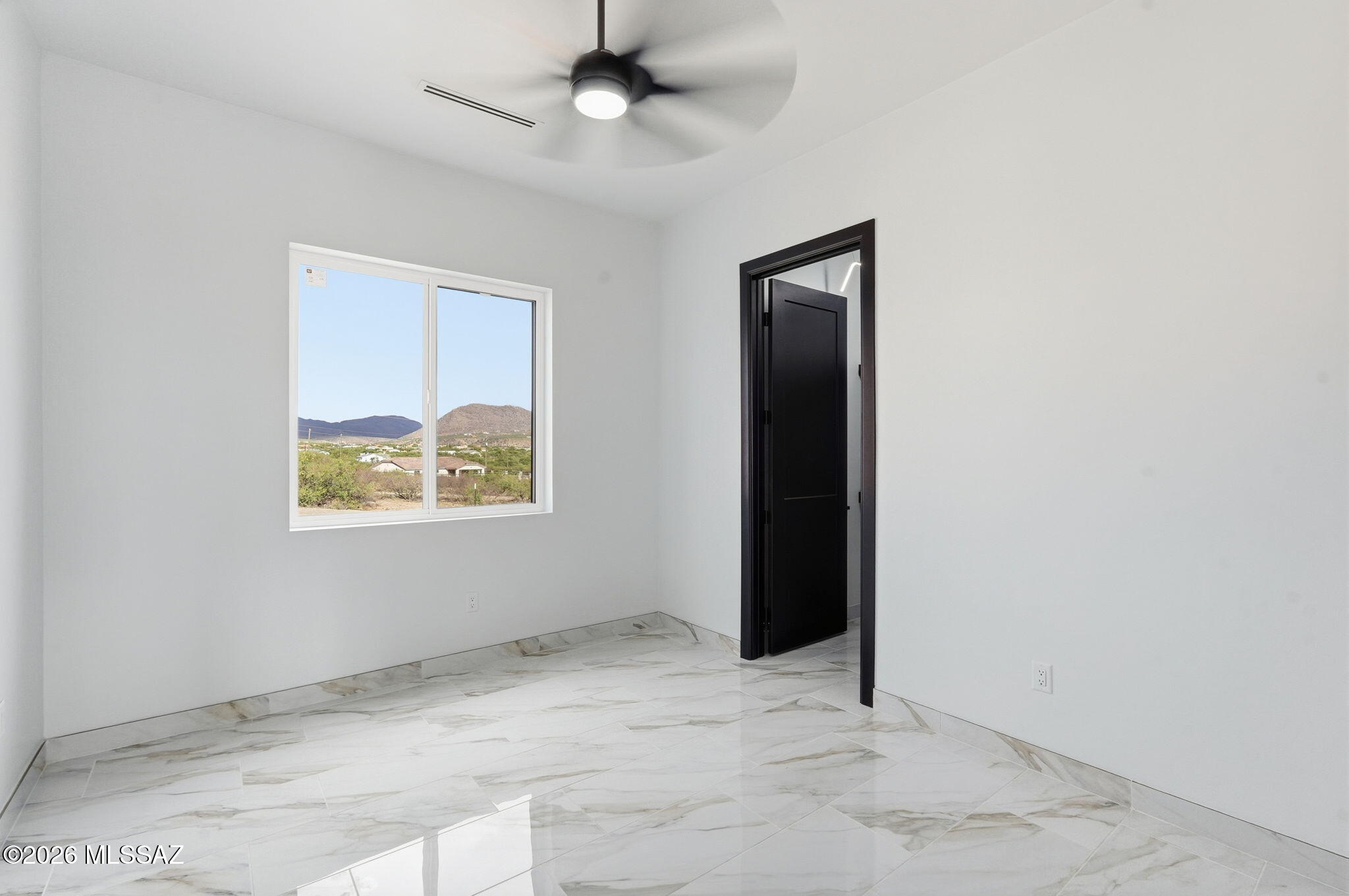 1786 Peralta Court Rio Rico, AZ 85648 - Photo 41 of 50 an empty room with windows and fan