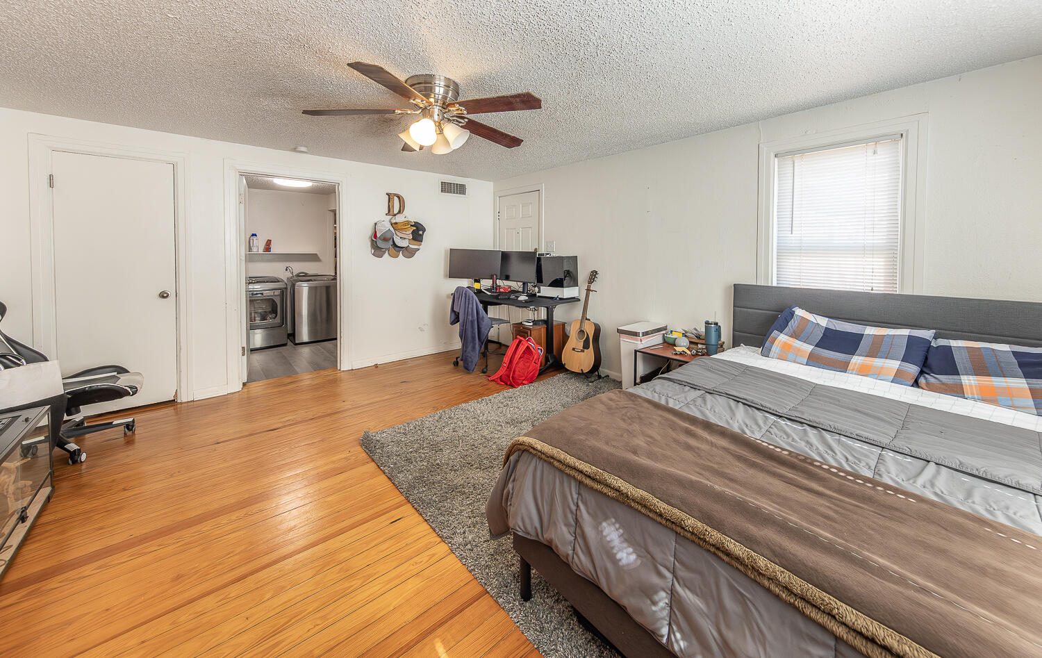 2301 27th Street Lubbock, TX 79411 - Photo 14 of 22 a bedroom with a bed and a chandelier