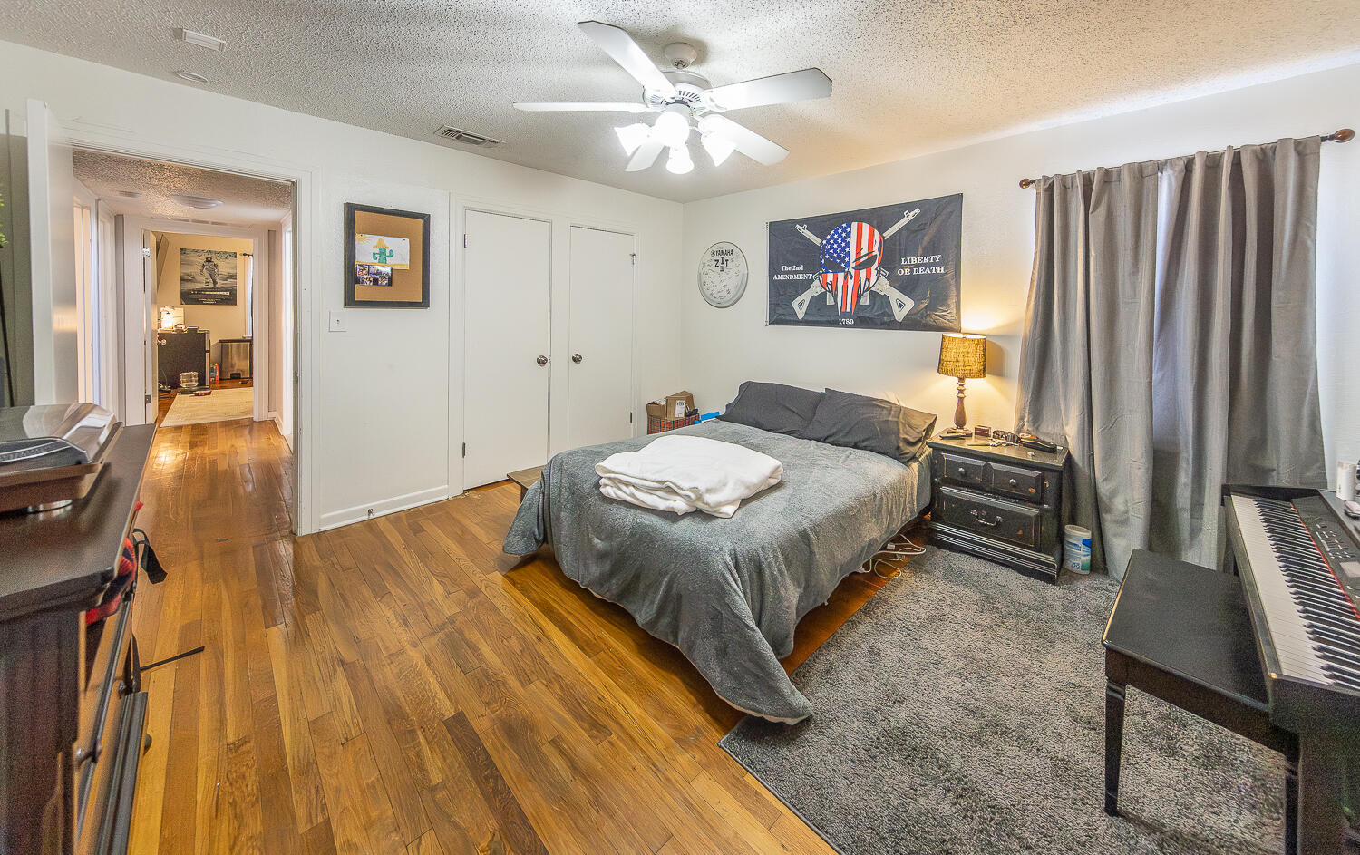 2301 27th Street Lubbock, TX 79411 - Photo 15 of 22 a bedroom with a bed and a chandelier