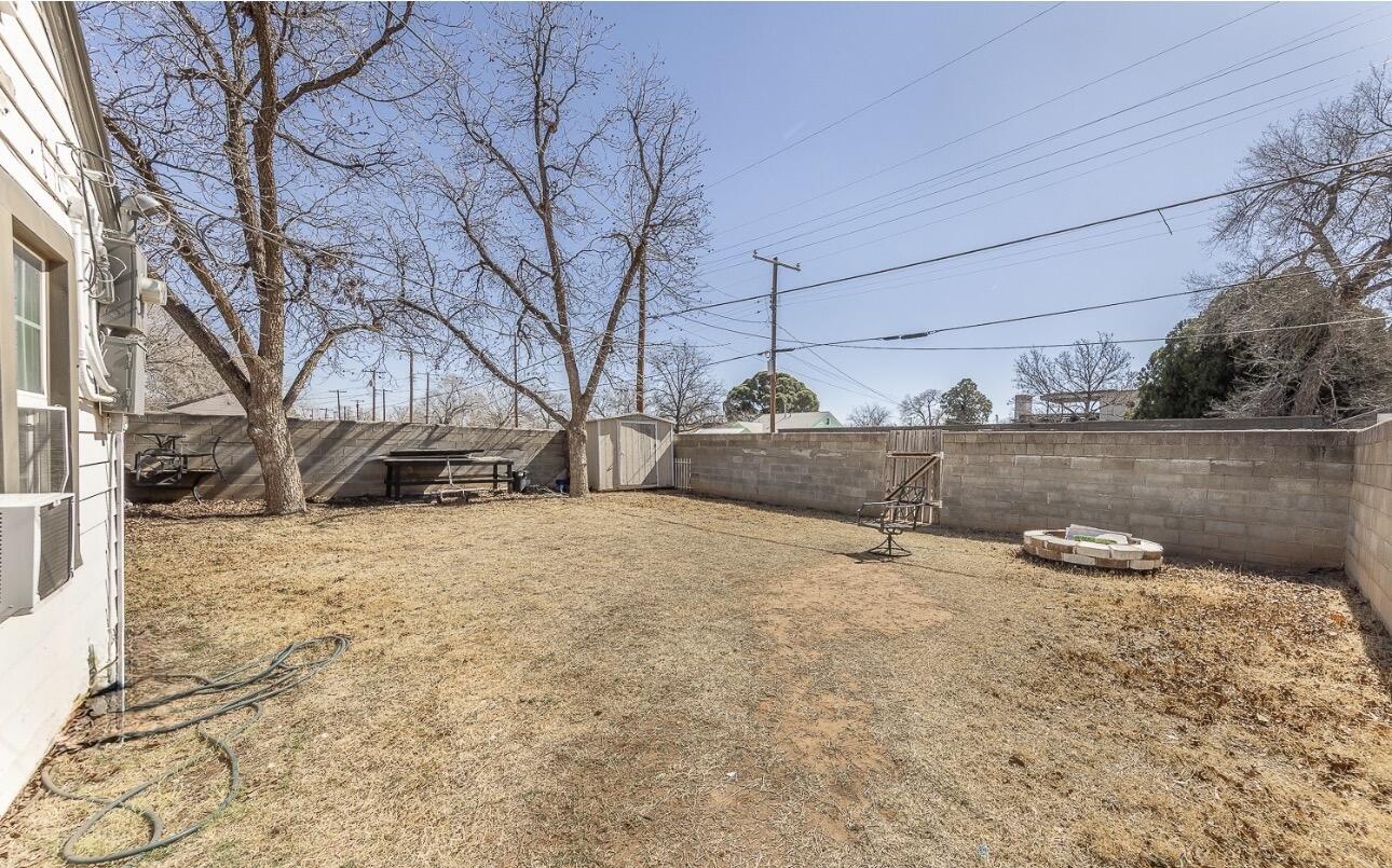 2301 27th Street Lubbock, TX 79411 - Photo 17 of 22 a backyard of a house with a large tree