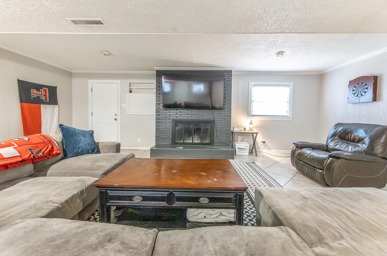 2301 27th Street Lubbock, TX 79411 - Photo 7 of 22 a living room with furniture and a fireplace