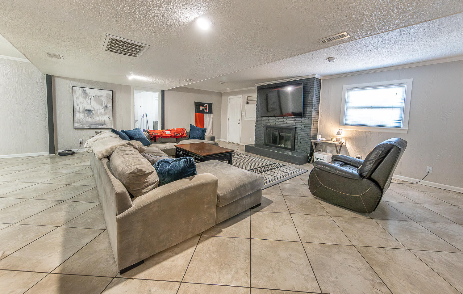 2301 27th Street Lubbock, TX 79411 - Photo 8 of 22 a living room with furniture and a flat screen tv